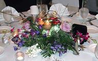 Centerpiece of Floating Candles in a Glass Ball, Peacock Feathers, Orchids, Roses...